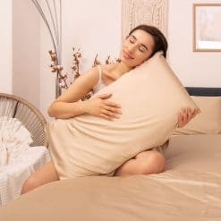 Hugging a pillow donned with the champagne bedding set cover