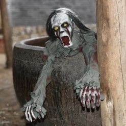 spooky crawling zombie poking it's head and arms out of a barrel